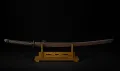 The Type 3 guntō mounted in its steel saya, displayed on a stand