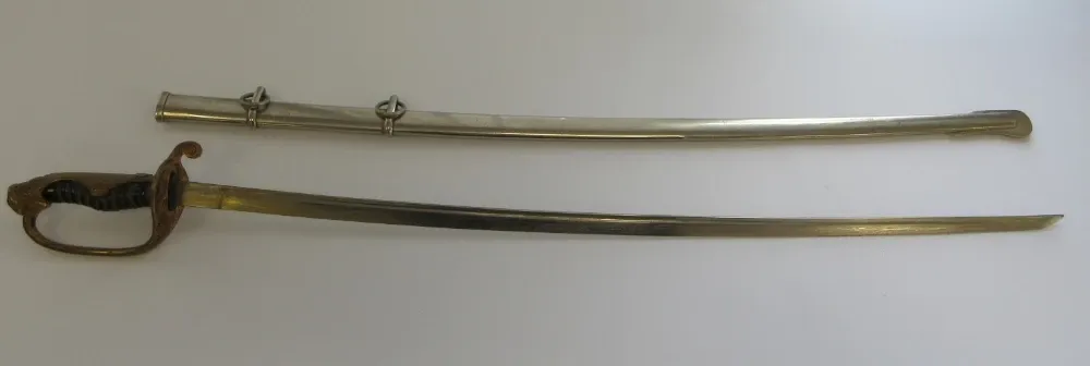 The saber in its bright nickel-plated scabbard beside the drawn blade, showing the full Type 19 kyū-guntō fittings