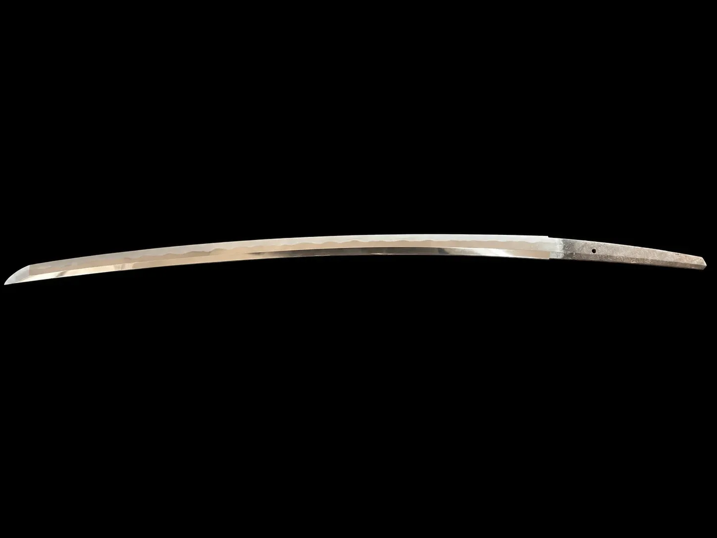 The bare blade laid out in full on a black ground, showing the curve, the fresh polish and the signed nakago