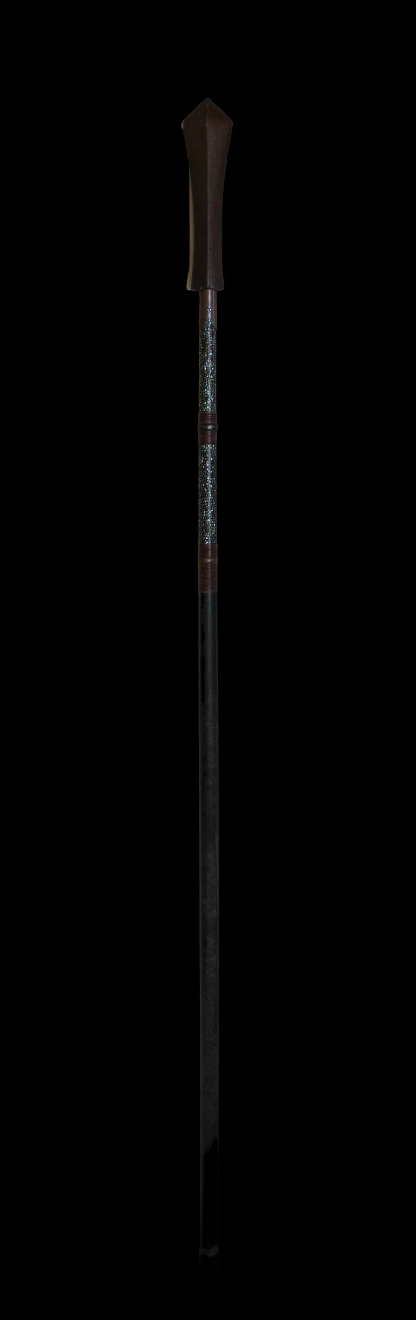 The signed yari shown in full on a black ground: the black-lacquer pole, the abalone-inlaid mounting and the metal butt cap