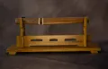 The tantō in its plain wood aikuchi mounting, on a stand
