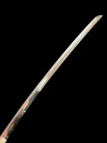 The full blade seen from the point down towards the machi, with the gunome-midare hamon running its length