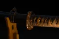The fuchi and menuki seen closer along the grip