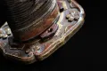 Tsuka detail with brown ito wrap and visible menuki