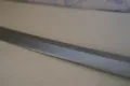 A close view of the blade, showing the sanbonsugi gunome temper line