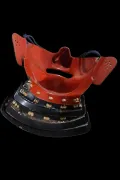 The inside of the mask, showing the vermilion lacquer interior and the navy silk cords