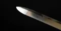 The spear point from a second angle, showing the polish and the facets of the point
