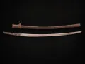 The leather combat cover over the saya, laid above the bare blade