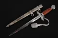 The dagger drawn beside its scabbard, showing the full second-model pattern with the bullion troddel attached
