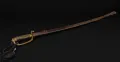 The complete sabre in its scabbard, the black sword tassel hanging from the knuckle bow