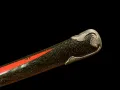 The green-fleck lacquer saya with its band of red lacquer and the shaped metal kojiri