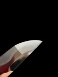 The kissaki from a second angle, the yokote and the polished point catching a warm reflection