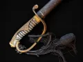 The black sword tassel laid out from the hilt, its cord and frayed skirt visible