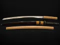 The complete set laid out together: the blade in its shirasaya hilt, the mounted koshirae with its green-fleck saya and gold sageo, and the shirasaya scabbard