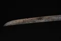 The full length of the blade seen edge-on against black