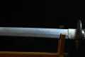The nioi-based gunome hamon (temper line) along the blade, with the habaki and tsuba beyond