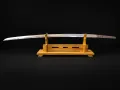 The bare blade resting on a wooden stand, showing its full profile and curvature