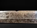 The blade surface close up, where the tired polish leaves the hada faint